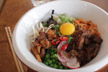 japanese sticky rice bowl with tamari pork, buttered chanterelles, miso aubergine, kimchi, taberu rayu and peas + a raw Nurney Farm egg yolk